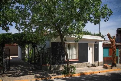 a house with a tree in front of it at flia Fortuna in Mina Clavero