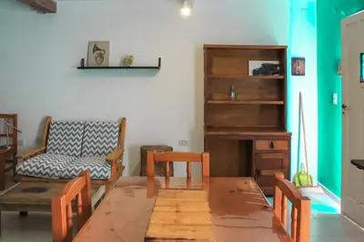 a living room with a table and a chair at flia Fortuna in Mina Clavero
