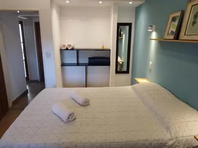 a large white bed with two pillows on it at Complejo Quiya - Casa El Algarrobo in Alta Gracia