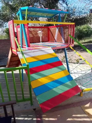 a colorful playground with a colorful slide at Complejo Quiya - Casa El Algarrobo in Alta Gracia