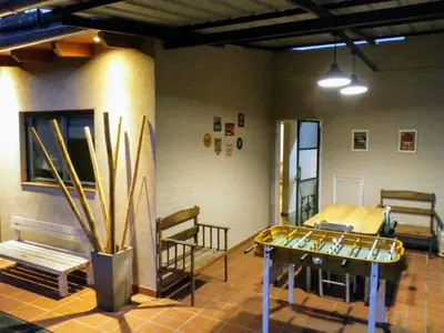 a room with a table and benches in a room at Complejo Quiya - Casa El Algarrobo in Alta Gracia