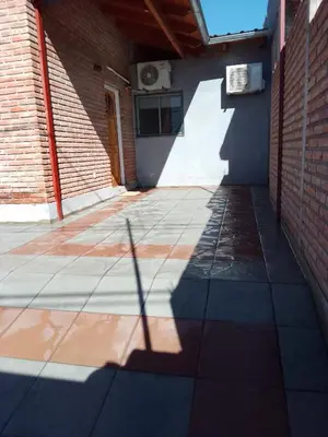 a shadow of a building with a building at Complejo Quiya - Casa El Algarrobo in Alta Gracia