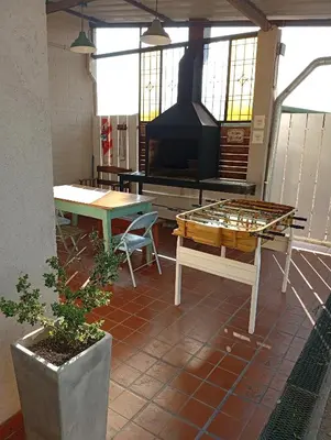 a patio with a table and a fireplace at Complejo Quiya - Casa El Algarrobo in Alta Gracia