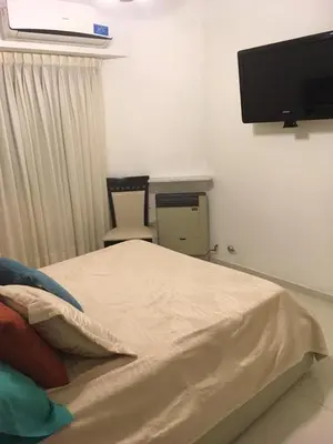 a bedroom with a bed and a flat screen tv at Fabuloso Carlos Paz in Villa Carlos Paz