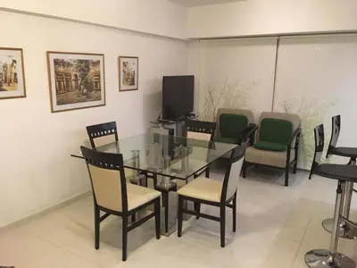 a dining room with a glass table and chairs at Fabuloso Carlos Paz in Villa Carlos Paz