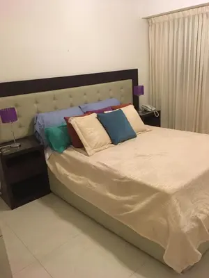 a bedroom with a large bed with pillows on it at Fabuloso Carlos Paz in Villa Carlos Paz
