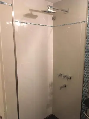 a bathroom with a shower with a plane on the wall at Fabuloso Carlos Paz in Villa Carlos Paz