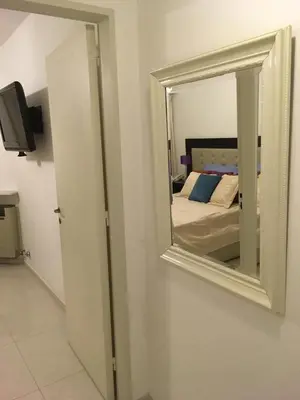 a mirror on a wall next to a bedroom at Fabuloso Carlos Paz in Villa Carlos Paz
