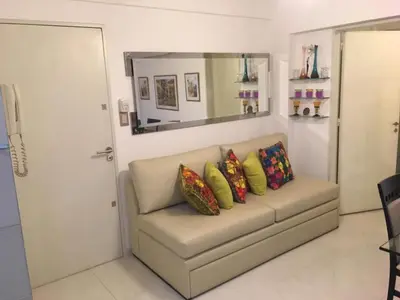 a couch with pillows on it with a mirror at Fabuloso Carlos Paz in Villa Carlos Paz