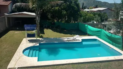 a blue swimming pool in a yard with a fence at Casa Grande in Villa Carlos Paz