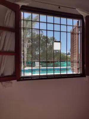 a window with a view of a swimming pool at Casa Grande in Villa Carlos Paz