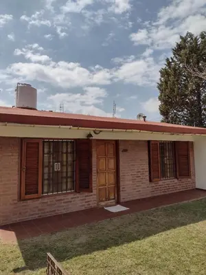 an old brick house with a red roof at Casa Grande in Villa Carlos Paz