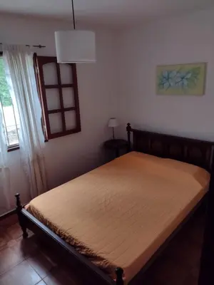 a bedroom with a bed in a room with a window at Casa Grande in Villa Carlos Paz