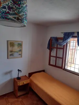 a bedroom with a bed and a window at Casa Grande in Villa Carlos Paz