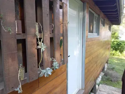 a door to a house with flowers on it at Cabañas Piedras del Xanaes, colindantes al río in Villa Los Aromos