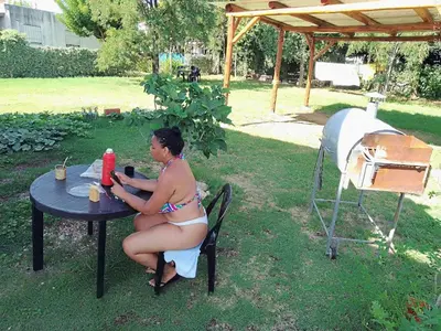 a woman in a bikini sitting at a table at departamentos sosa in Mina Clavero