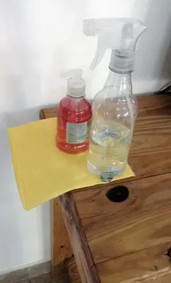 two bottles of water sitting on a wooden table at departamentos sosa in Mina Clavero