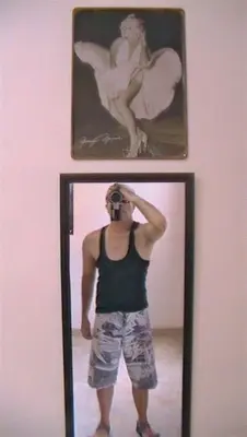 a man taking a picture of himself in a mirror at departamentos sosa in Mina Clavero
