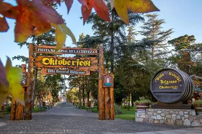 a park with signs in a park with trees at Rumihuasi Apartamento in Los Reartes