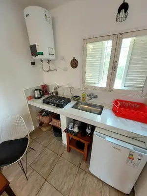 a kitchen with a sink and a counter top at Rumihuasi Apartamento in Los Reartes