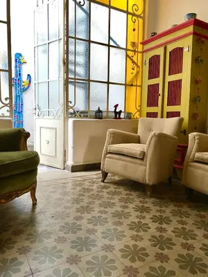 a living room with two chairs and a window at Santa Rosa in Cordoba