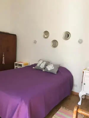 a bedroom with a purple bed with lights on the wall at Santa Rosa in Cordoba