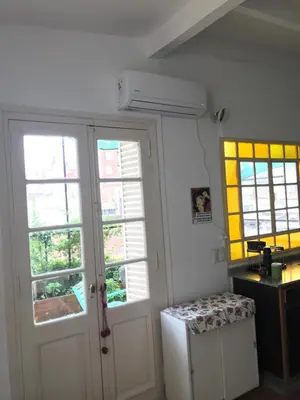 a room with two windows and a white refrigerator at Santa Rosa in Cordoba