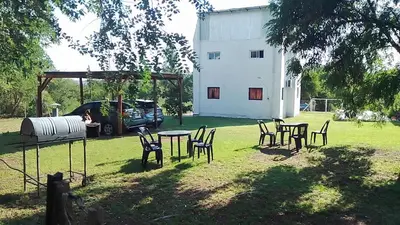 a group of tables and chairs in a yard at DEPARTAMENTOS SOSA in Mina Clavero