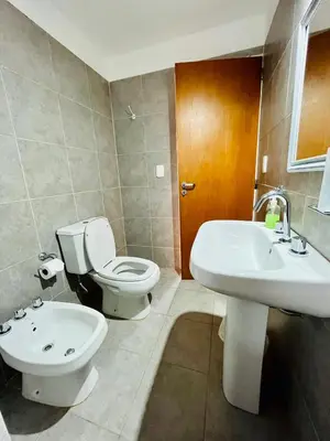 a bathroom with a toilet and a sink at Mirador del Valle in Mina Clavero