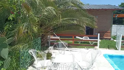 a group of white chairs next to a pool at Complejo 