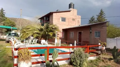 a house with a pool in front of a house at Complejo 