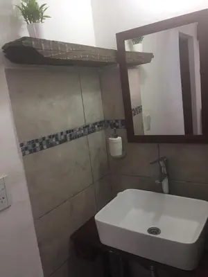 a bathroom with a white sink and a mirror at Benito Soria 137 in Santa Rosa de Calamuchita