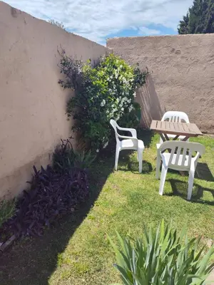two chairs and a table and a table and a bench at Benito Soria 137 in Santa Rosa de Calamuchita
