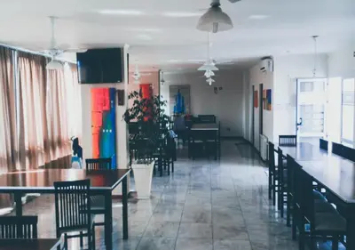 a restaurant with tables and chairs and a dining room at Departamento Carlos Paz, Centro in Villa Carlos Paz