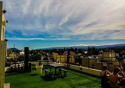 a group of people sitting on the roof of a building at Departamento Carlos Paz, Centro in Villa Carlos Paz