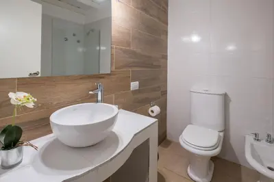 a bathroom with a white sink and a toilet at Calina Casa de Huéspedes in Villa General Belgrano