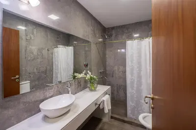 a bathroom with a sink and a mirror at Calina Casa de Huéspedes in Villa General Belgrano