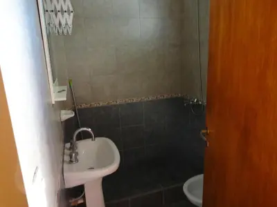 a small bathroom with a sink and a toilet at Rincón del Valle in Mina Clavero