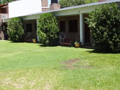 a porch of a house with a grass yard at Rincón del Valle in Mina Clavero