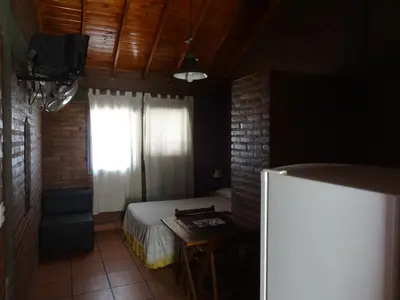 a small bedroom with a bed and a window at Rincón del Valle in Mina Clavero