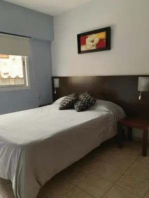 a bedroom with a bed with two pillows on it at Go Hostel in Cordoba
