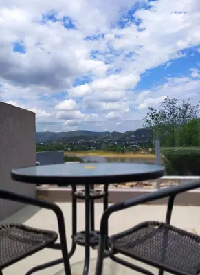 a table and chairs on a balcony with a view at Domus Lake Resorts in Villa Carlos Paz