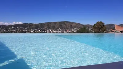 a large body of water with a city in the background at Domus Lake Resorts in Villa Carlos Paz