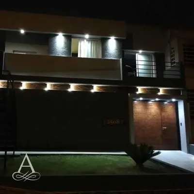 a building with lights on the side of it at night at Altos de Chacabuco Planta Alta Apartamento temporario amoblado premium con cochera gratis in Cordoba
