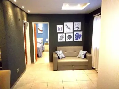 a living room with a couch and a bedroom at Altos de Chacabuco Planta Alta Apartamento temporario amoblado premium con cochera gratis in Cordoba