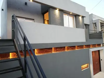 a house with a staircase in front of it at Altos de Chacabuco Planta Alta Apartamento temporario amoblado premium con cochera gratis in Cordoba