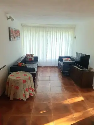 a living room with a couch and a table at Doña Haydee in Las Tapias
