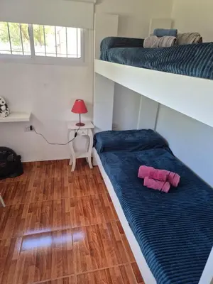 a bedroom with two bunk beds with pink towels on the floor at Doña Haydee in Las Tapias