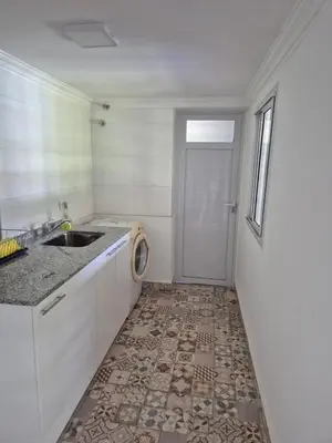 a kitchen with a sink and a washing machine at Doña Haydee in Las Tapias