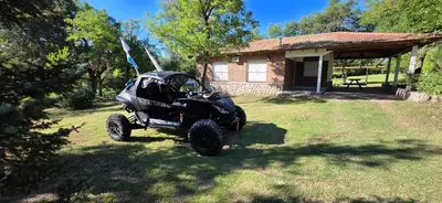 a black atv parked in front of a house at Hermoso Chalet en Nono in Nono